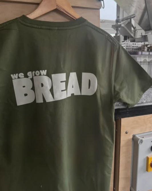 Olive green Plúr t-shirt with we grow BREAD printed on the back